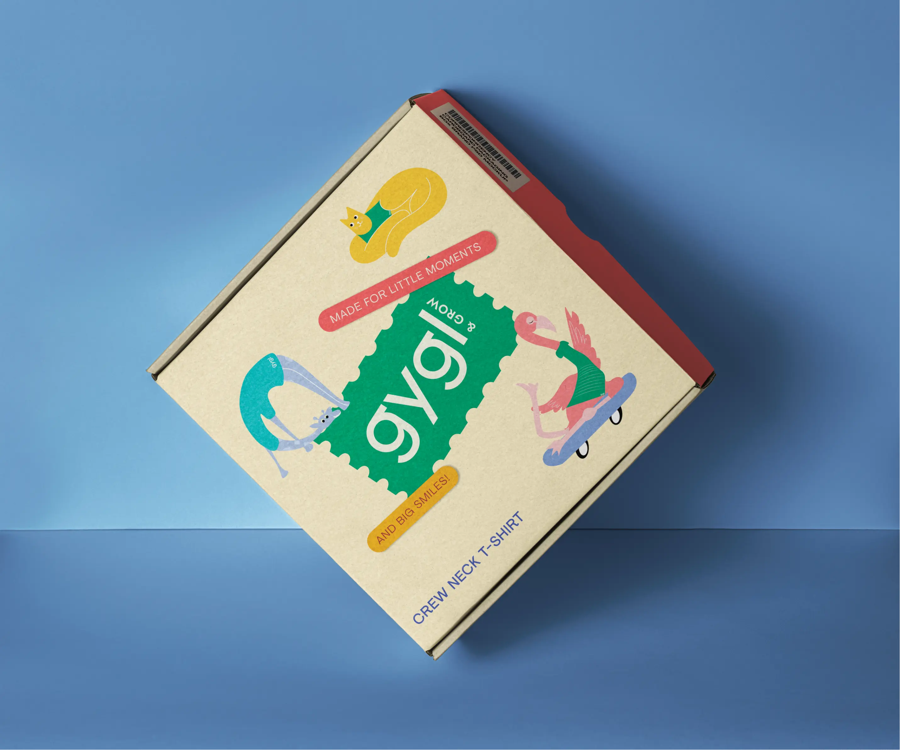 Cardboard box with colorful animal illustrations and text reading 'gygl & grow,' 'Made for little moments and big smiles,' and 'Crew Neck T-Shirt' on a blue background.
