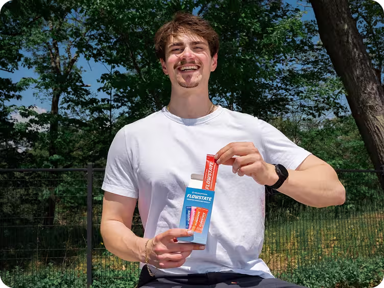 Person outdoors holding a Flowstate sachet