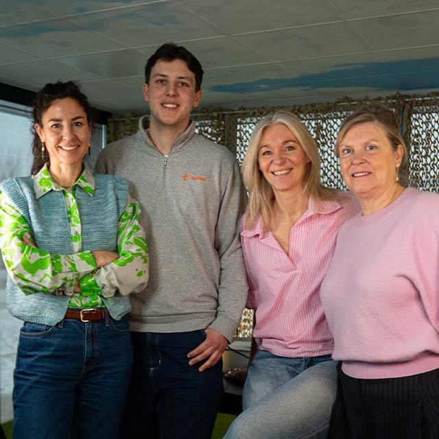 A person riding a bicycle in front of a large festival structure