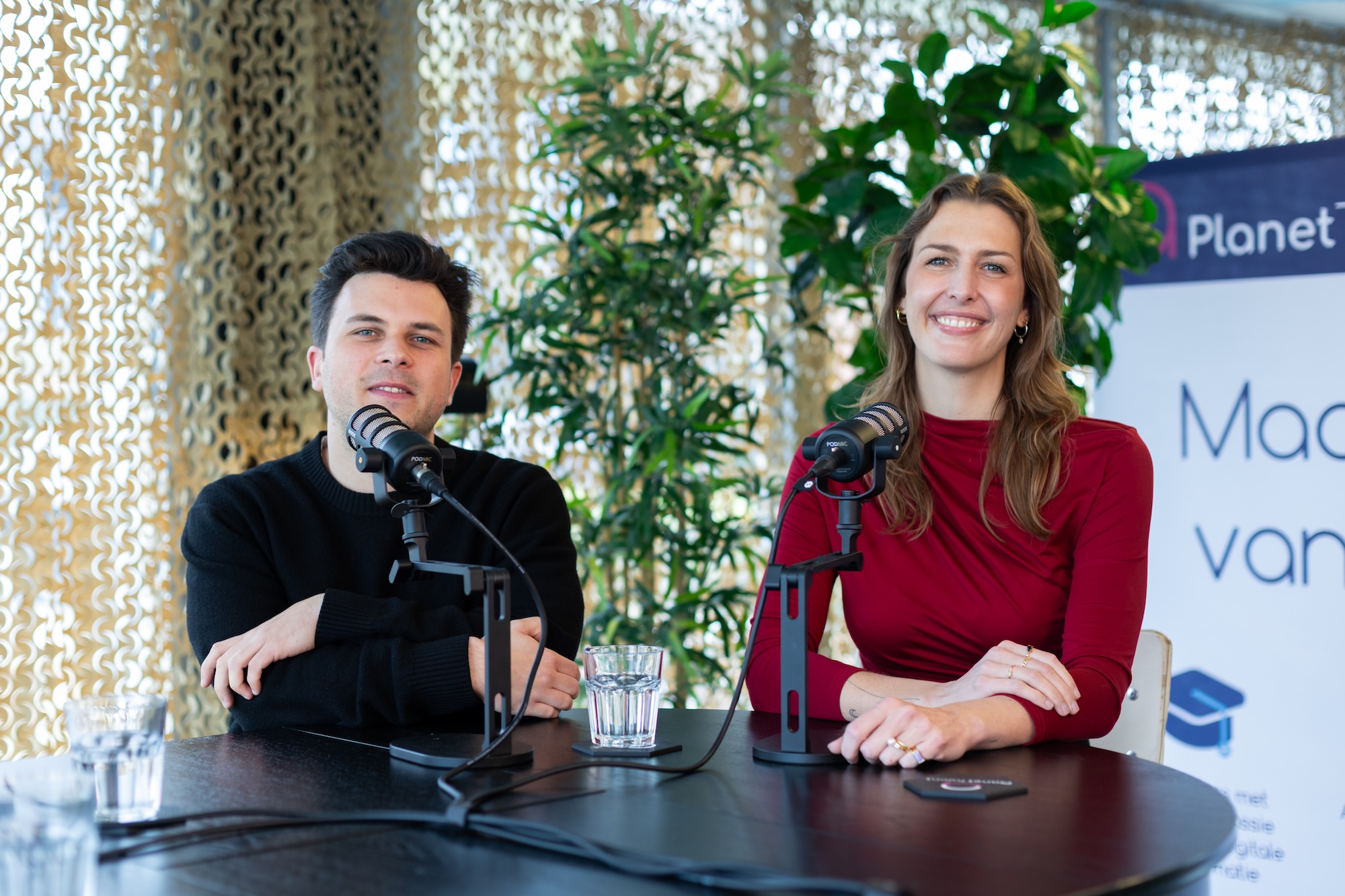 A person standing on a rocky shore looking at sea ice