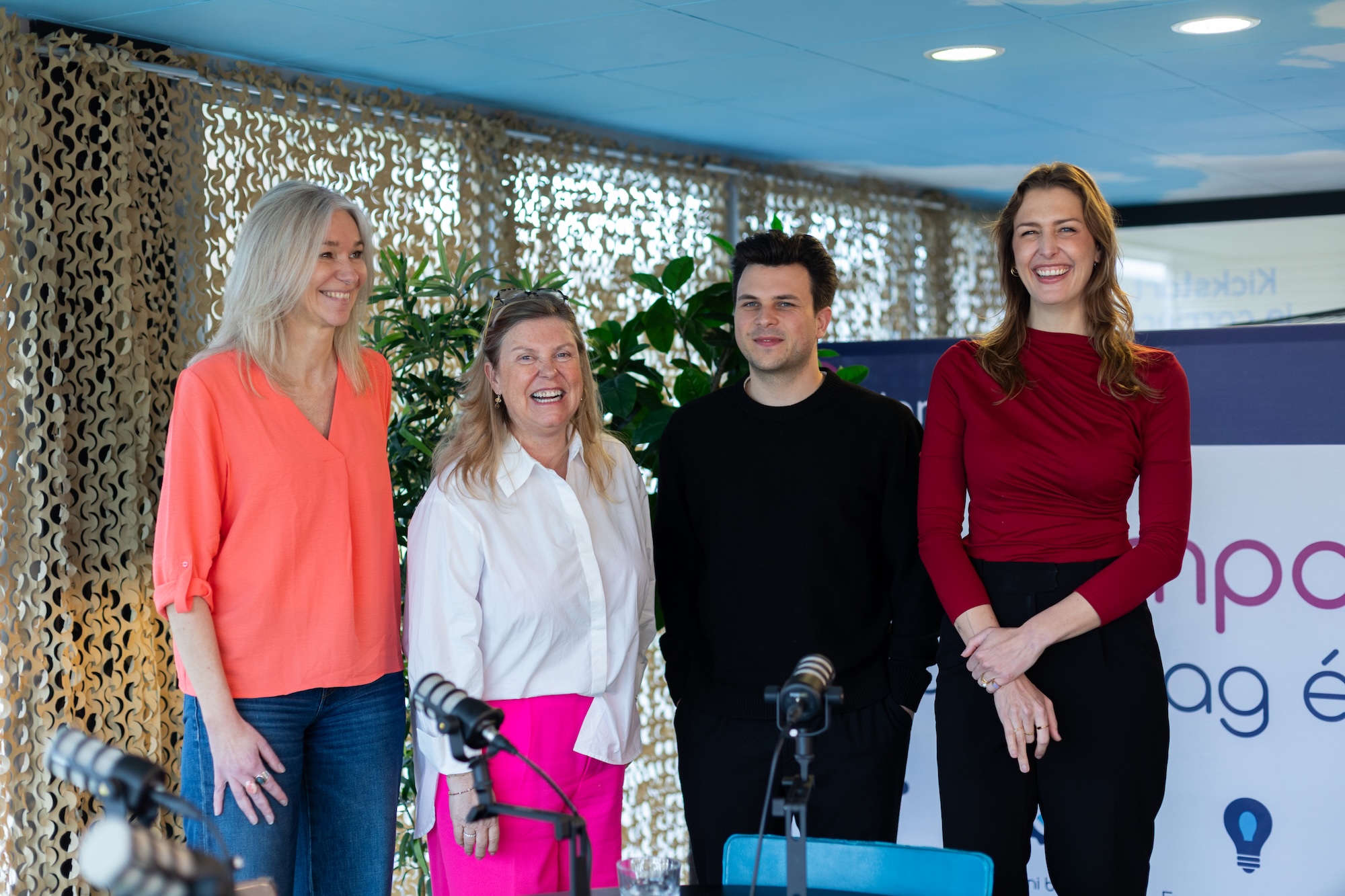 A person standing on a rocky shore looking at sea ice