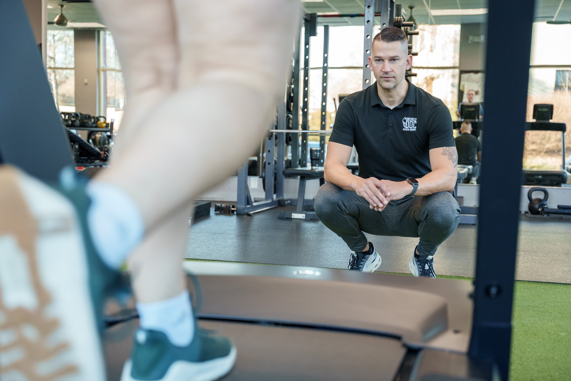 Physical therapist working one-on-one with runner in Durham, NC, demonstrating personalized running gait analysis and injury assessment