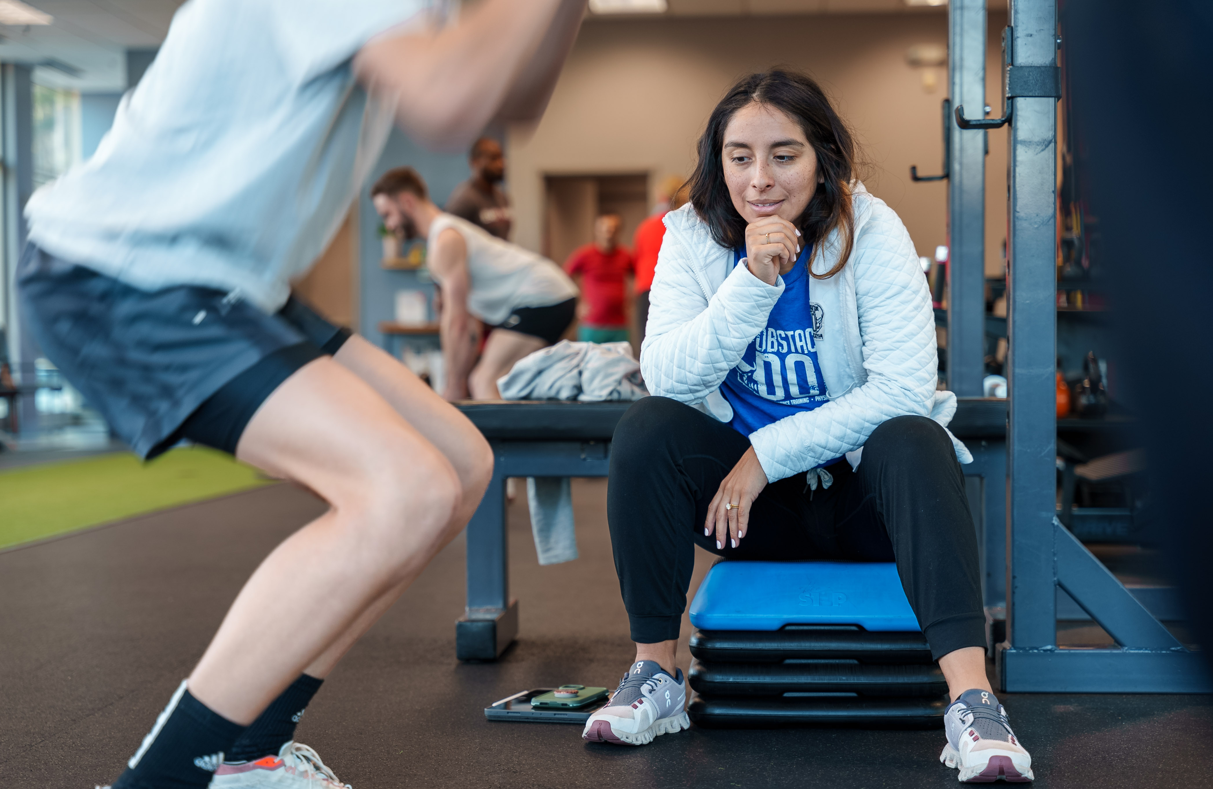 Physical therapist working one-on-one with runner in Durham, NC, demonstrating personalized running gait analysis and injury assessment