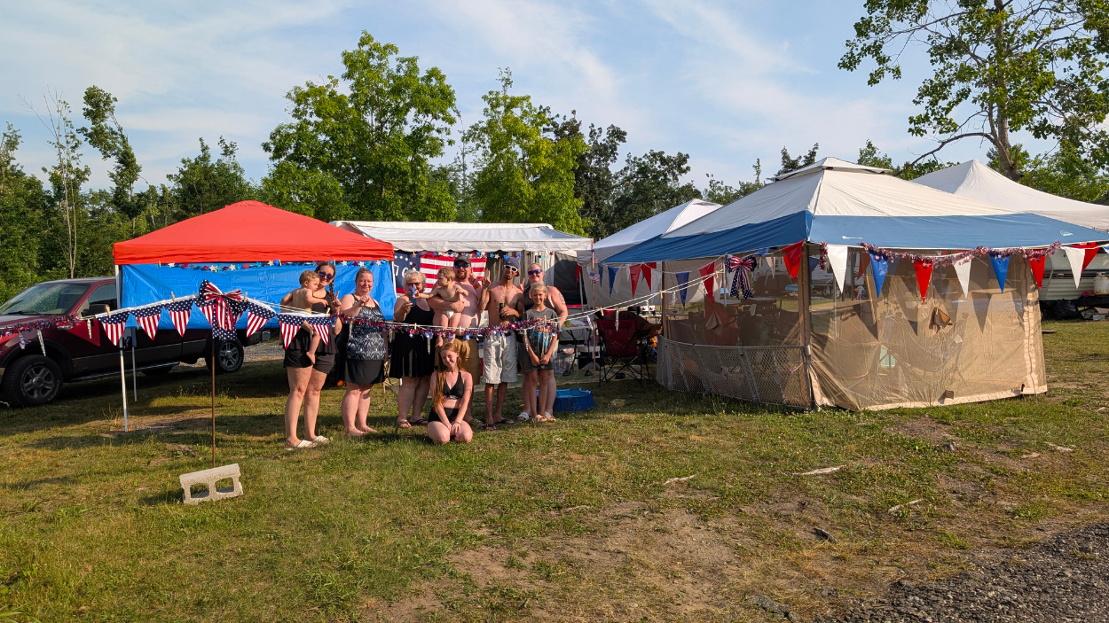 a family poses next to their winning site for the 4th of July decoration contest