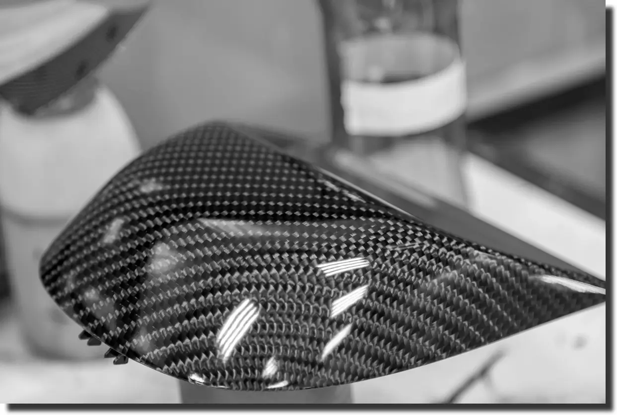 Glossy forged carbon-fiber side-mirror housing; sleek custom forged carbon fiber parts for cars demanding low weight and premium style.