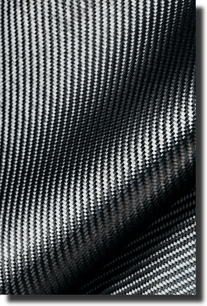Close-up twill carbon weave; texture reference for composite tooling design and fiber orientation decisions.