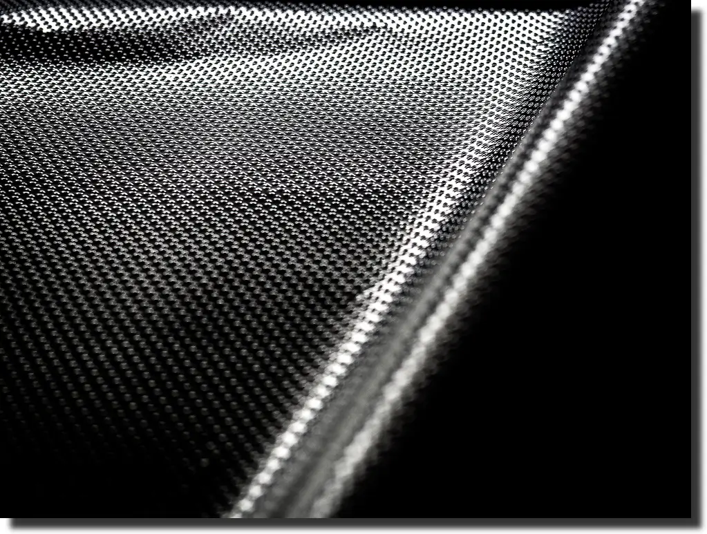 Carbon fiber sheet close-up with twill texture, illustrating carbon fiber vs aluminum strength in thin panels
