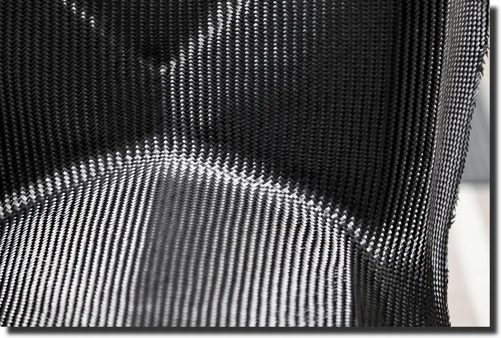 Carbon fiber seat shell close-up with woven pattern; lightweight part illustrating types of carbon fiber in performance components