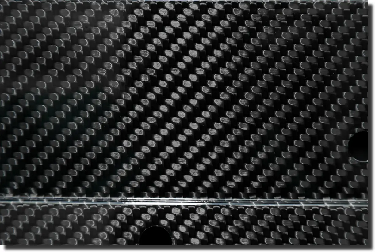 Glossy sheet of forged carbon fiber with marbled pattern, example of colored forged carbon fiber used on visible components.
