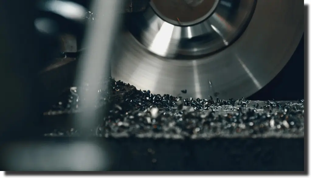 Industrial cutting tool removing material, showing how machining control protects carbon fiber strength at edges and interfaces.