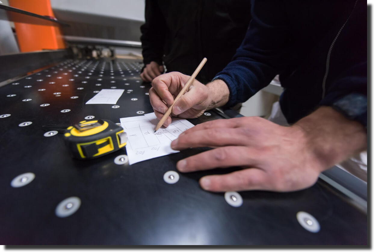 Worker measuring a carbon fiber panel, showing composite panel inspection of holes, datums, and surface features