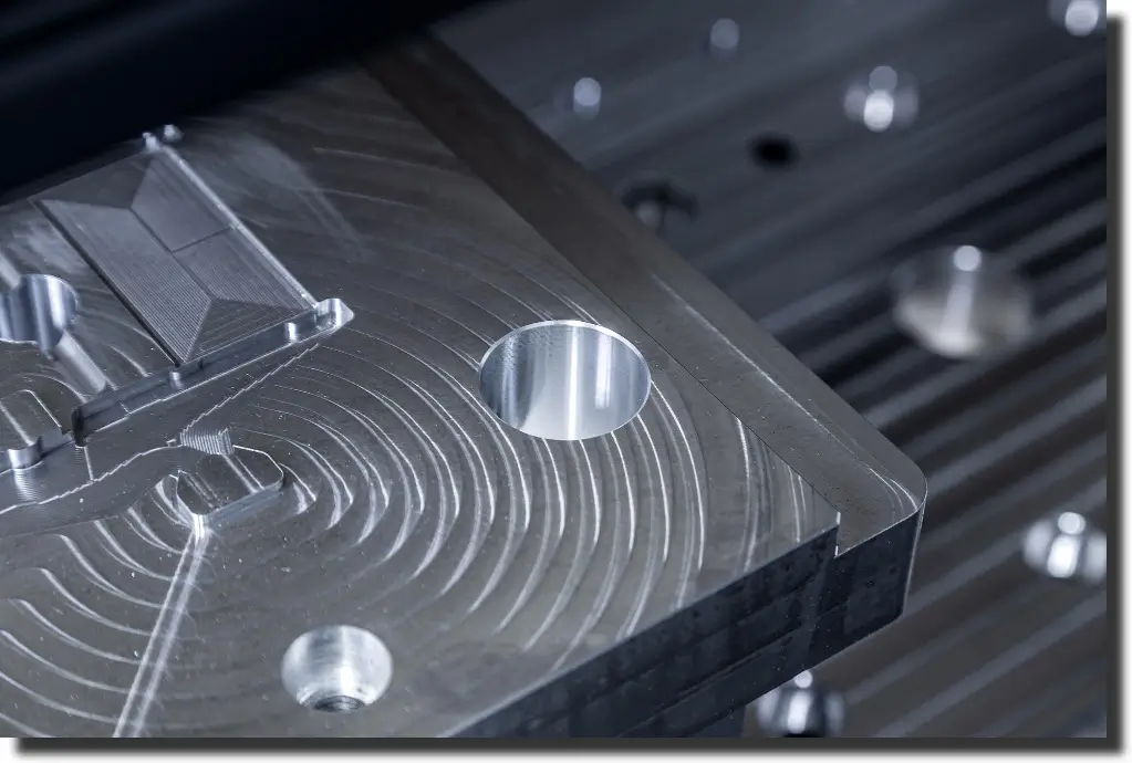Machined metal tool showing why carbon fiber machining needs a different cutting strategy than meta