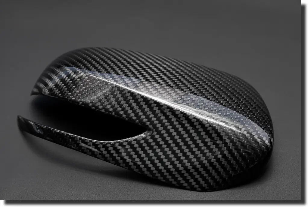 Glossy carbon fiber cover showing clear carbon fiber coating for protected visible weave and refined finish