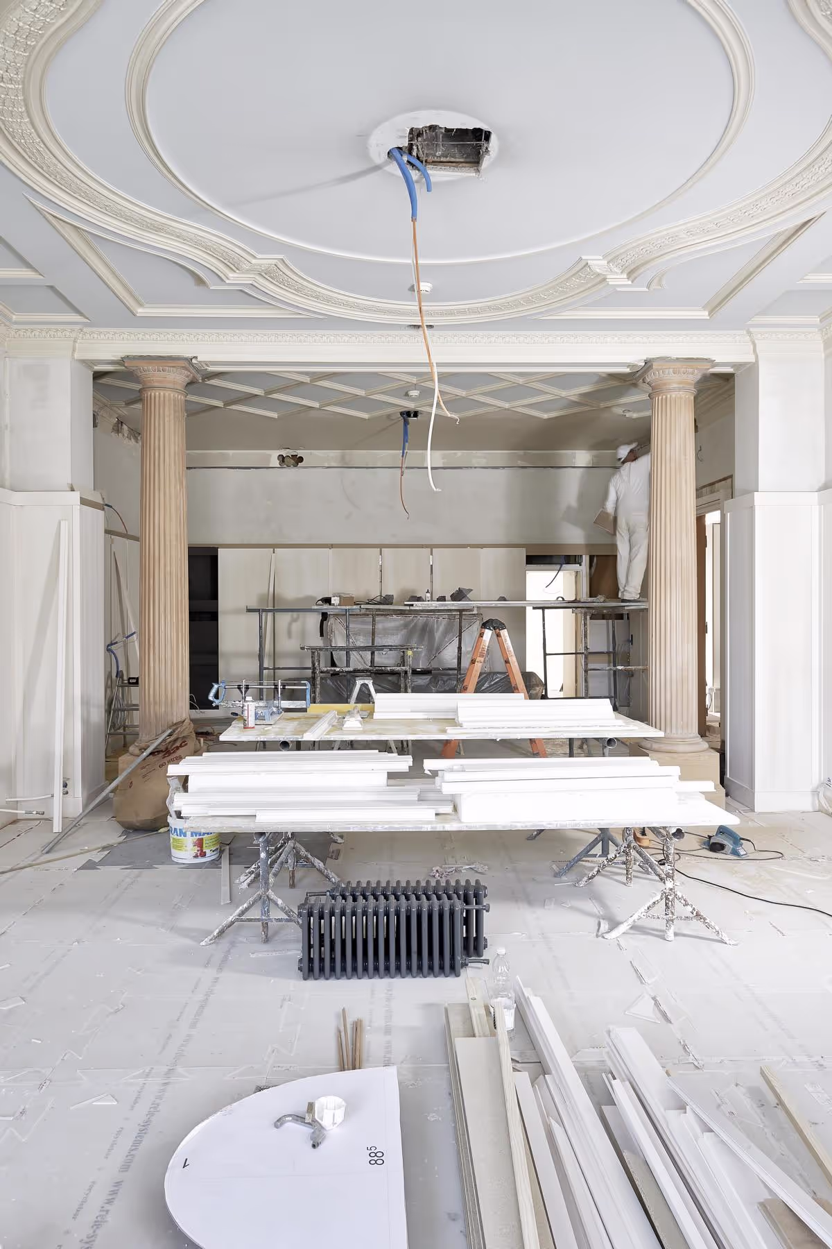 Elegant interior under construction with decorative ceiling.