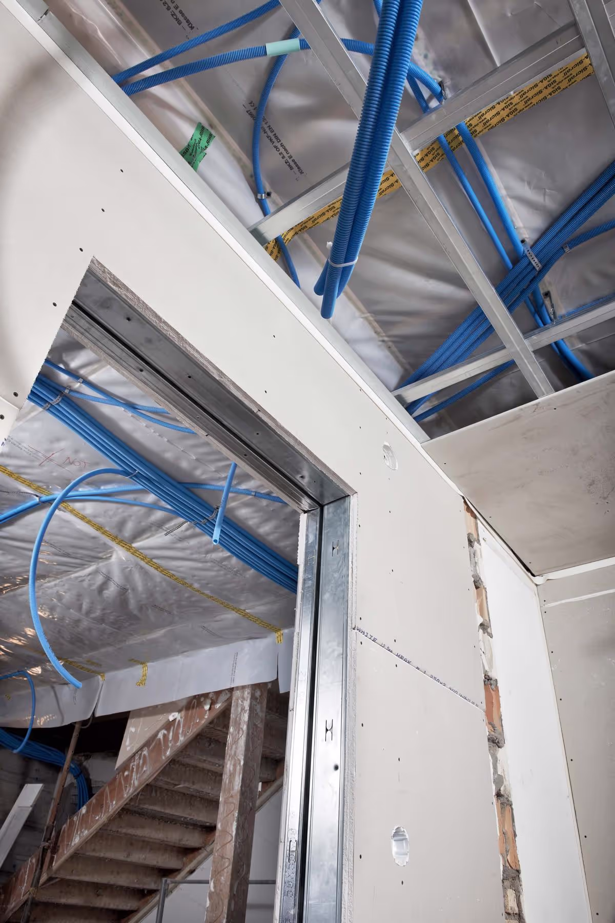 Construction site with metal framing and insulation.