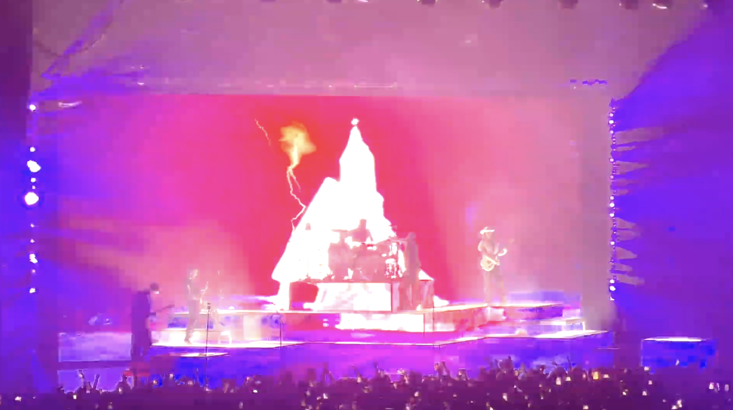Concert stage with dramatic white pyramid and lightning effect