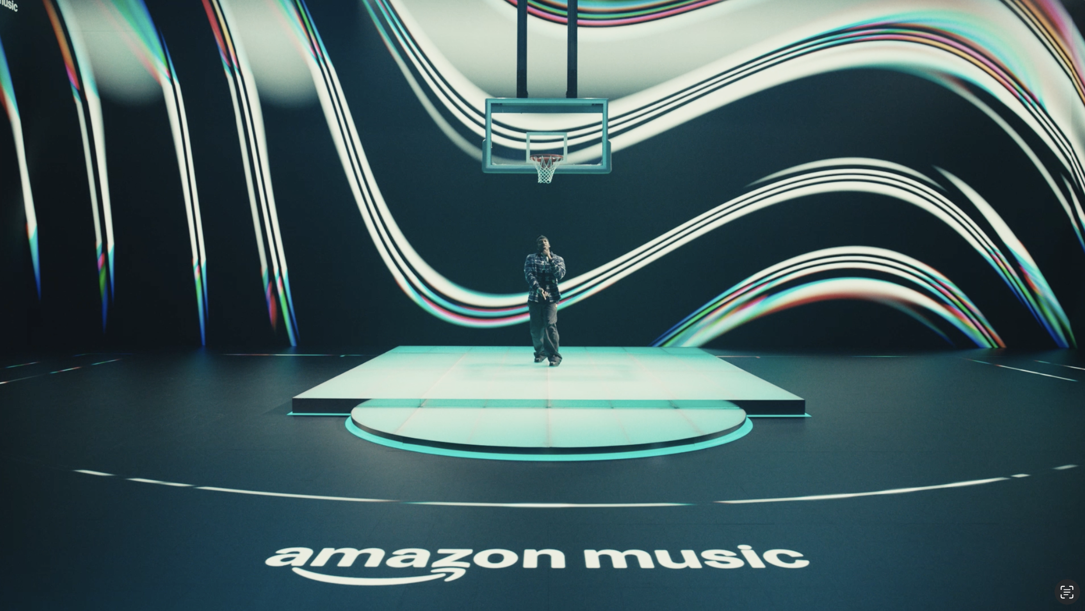 Amazon Music stage with wavy colorful backdrop and person standing on platform