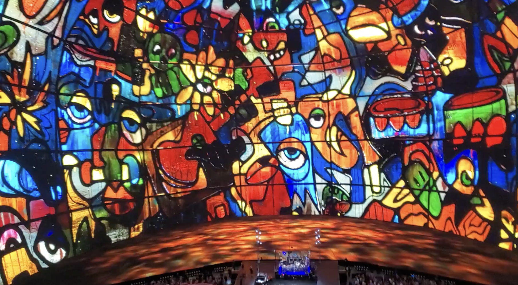 Vibrant abstract stained glass-like mural with geometric shapes and bold colors