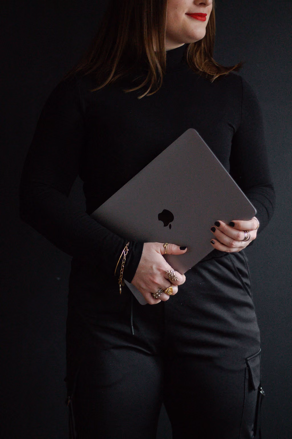 Hannah Hernandez holding a laptop in her arms.