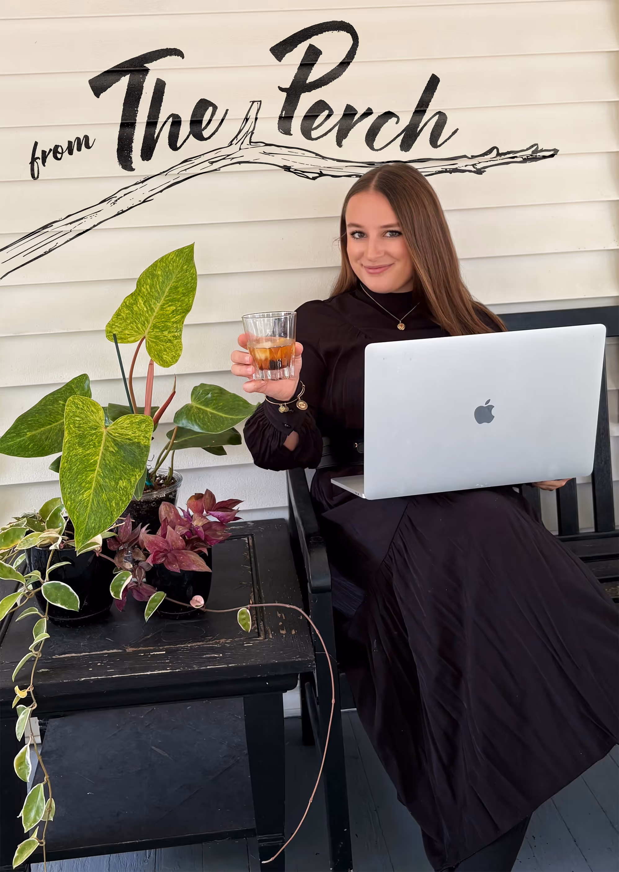 Hannah Hernandez sitting on a bench next to plants with her computer and an Old Fashioned.