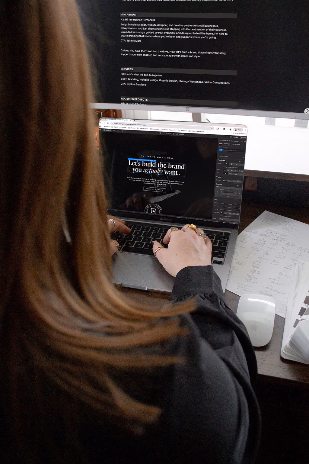Hannah Hernandez, owner of EQBM Design Company, typing on her computer and editing the copy on a website page.