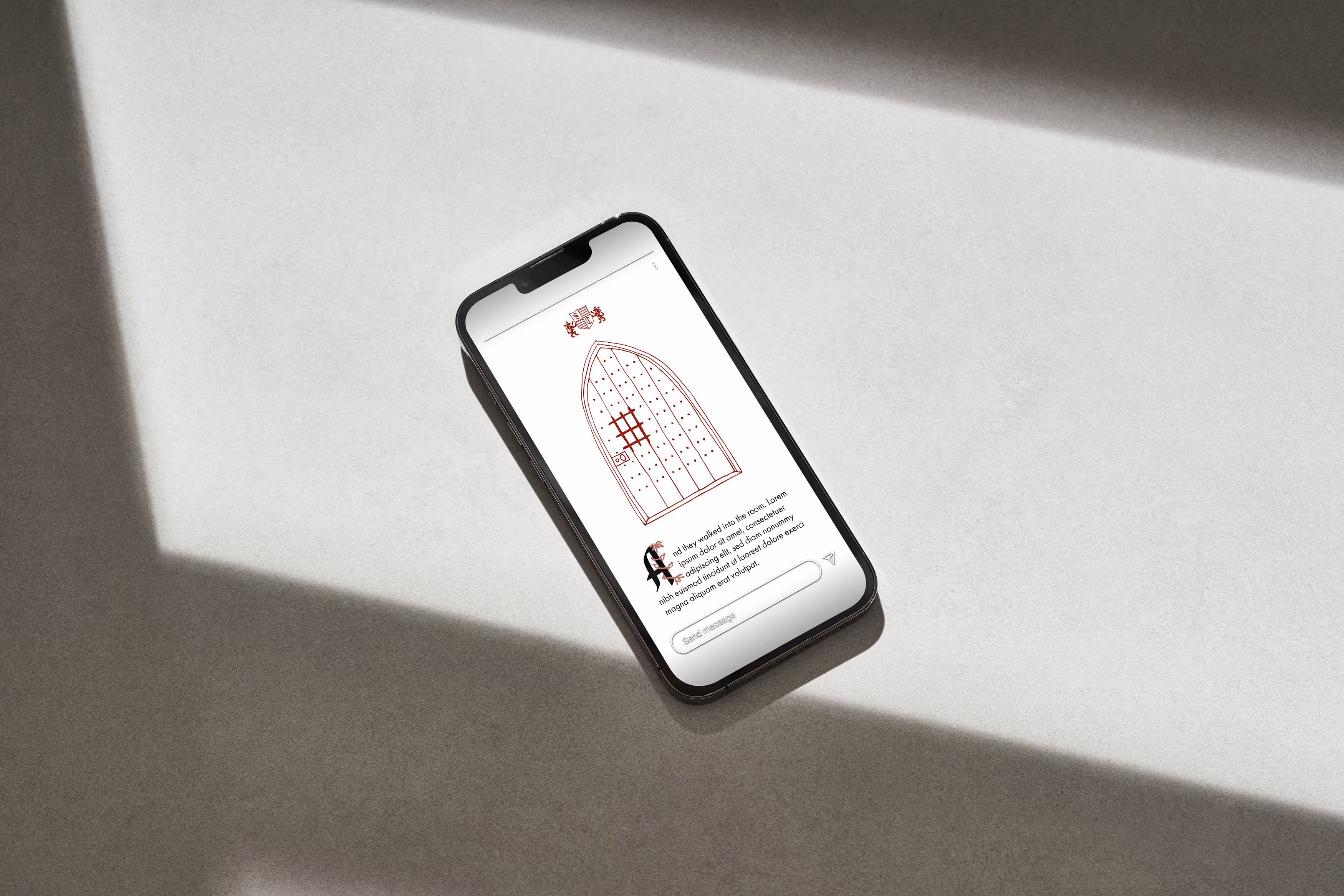 A phone lays on the floor. Open on the screen is a mockup of an Instagram story for the Soderstrom Castle showcasing a unique feature of Castle's architecture: the front door.
