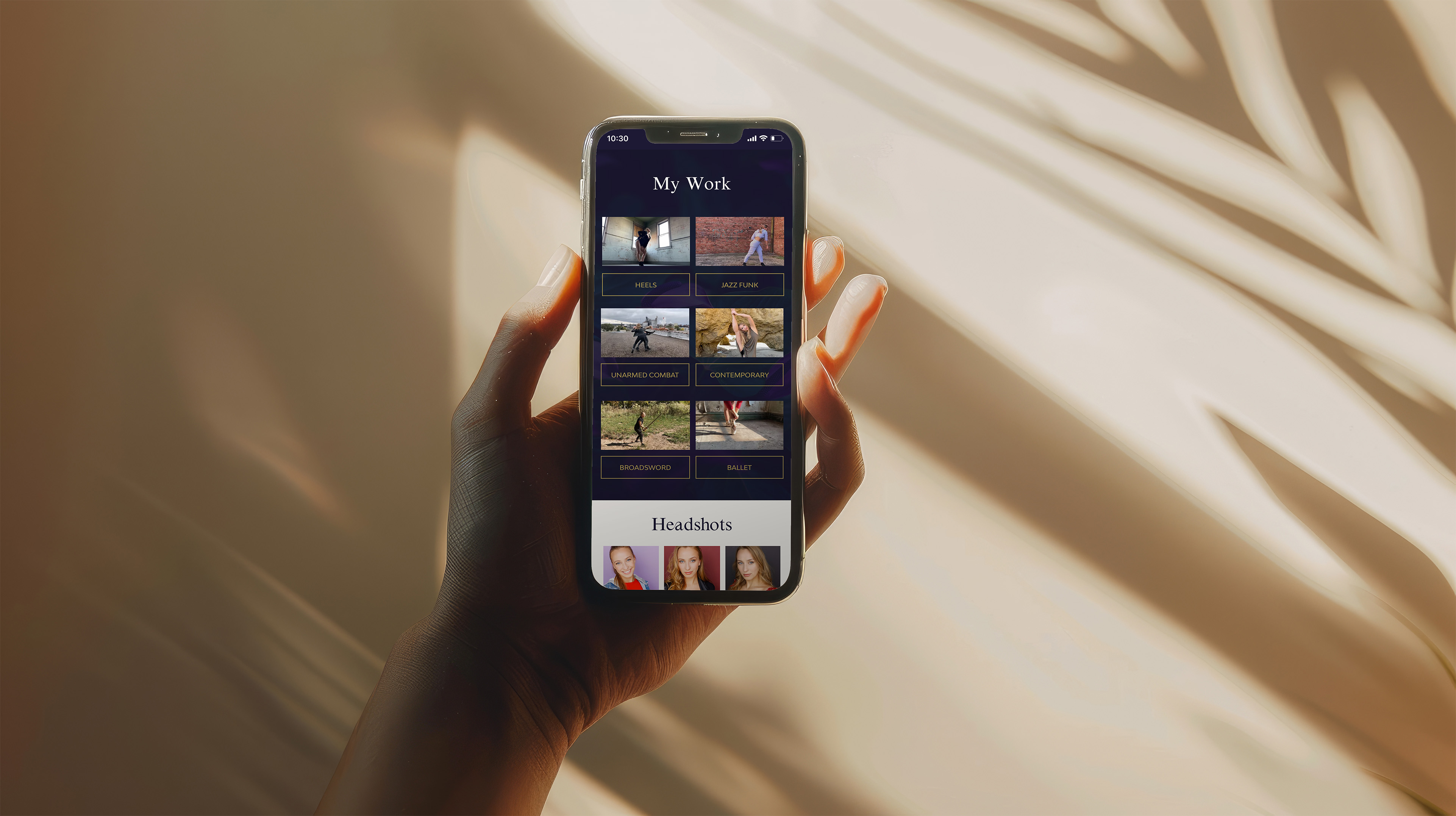 A person hold a mobile phone with a website preview for Fiona Whitson's website created by EQBM Design Company.
