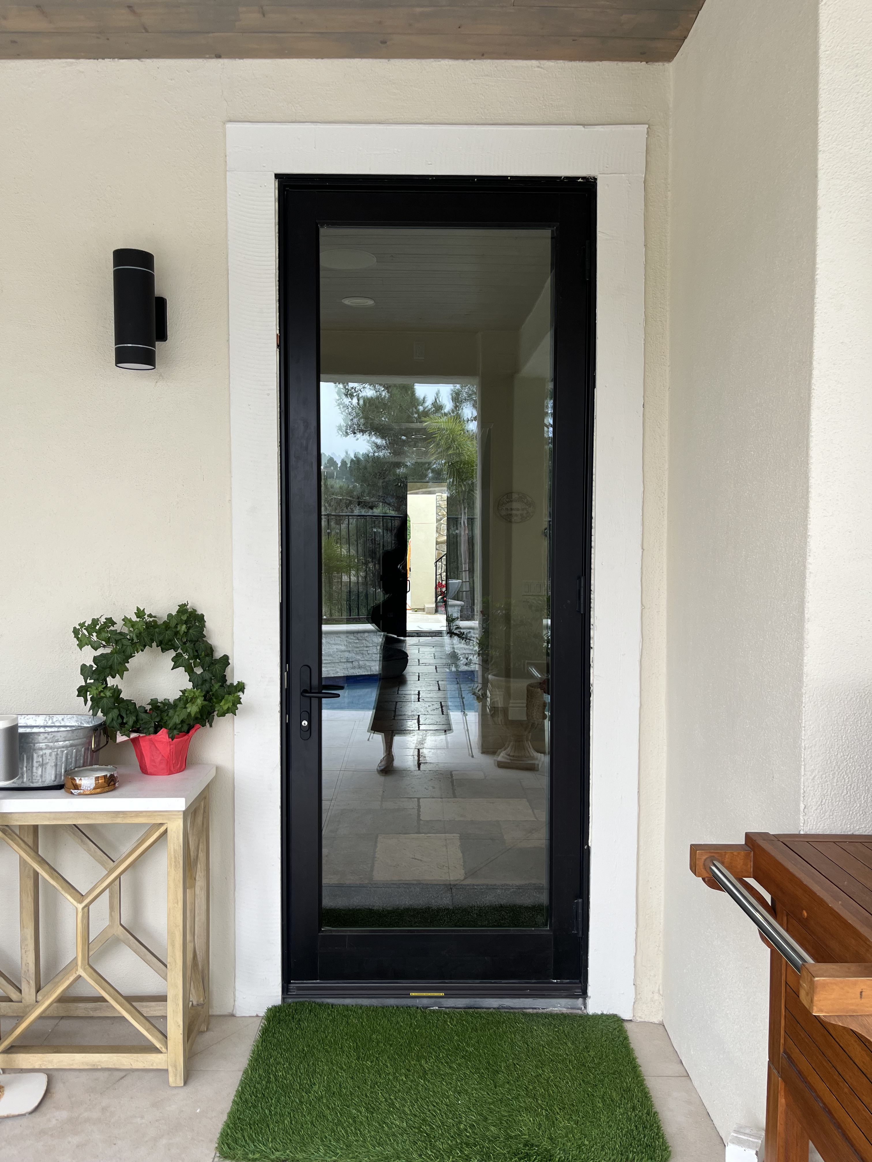 After: exterior view of new black patio door with larger glass area and brass French door knob
