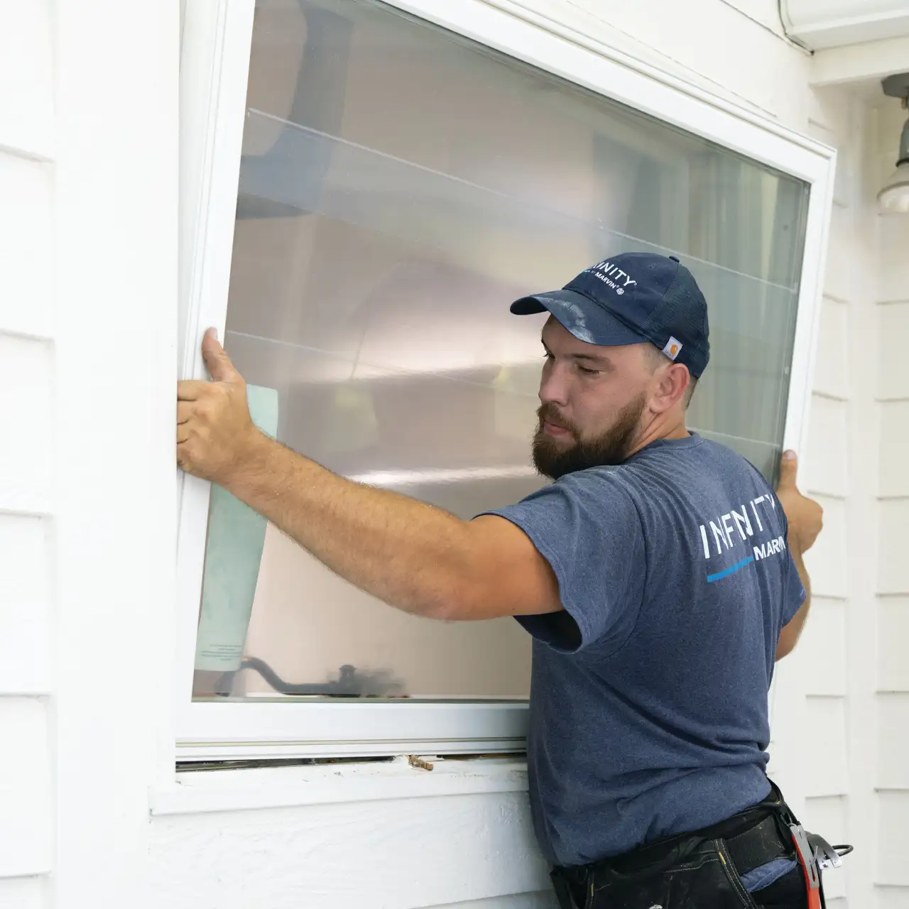 installer caulking a replacement window