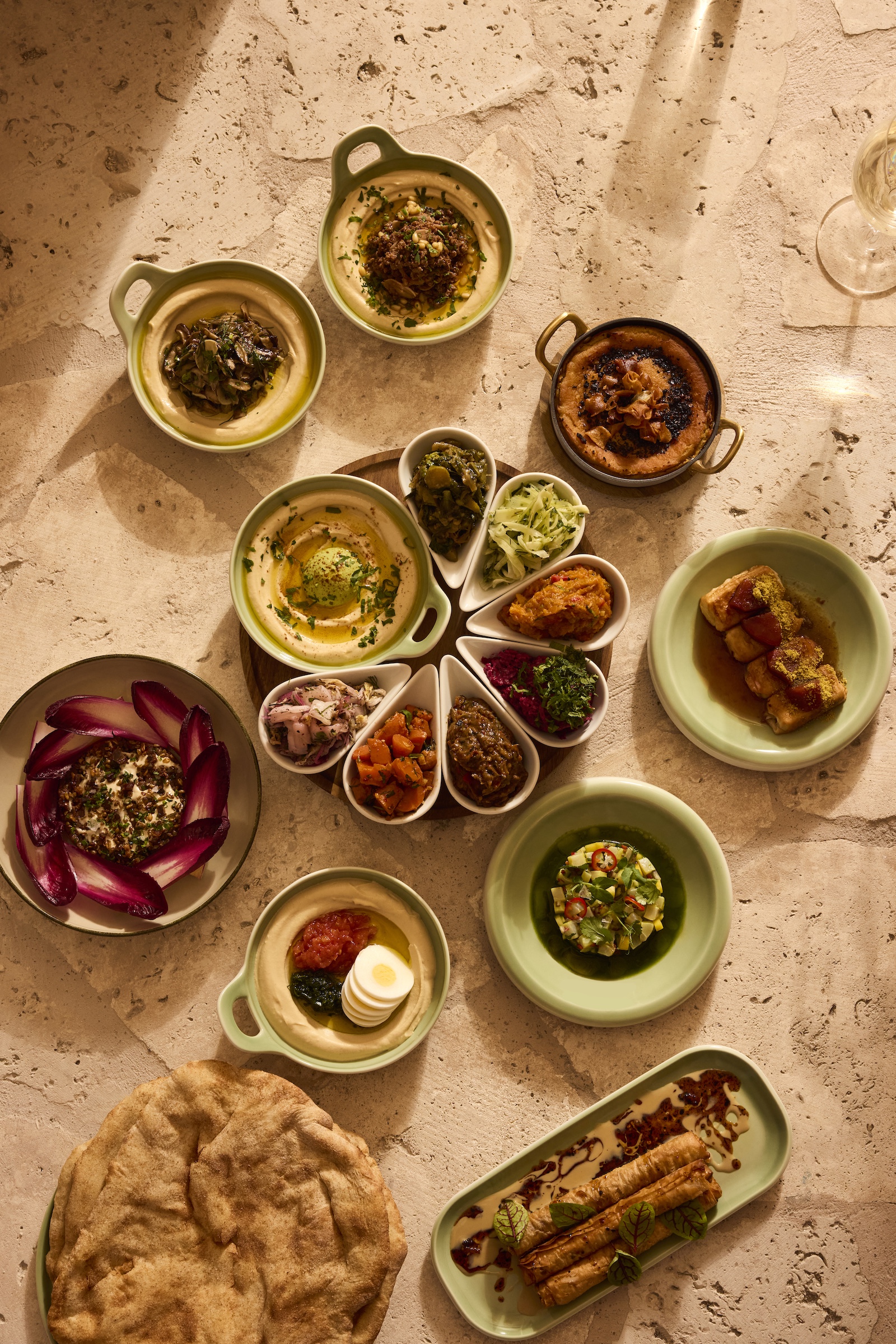 hummus and other dishes on earthen plates