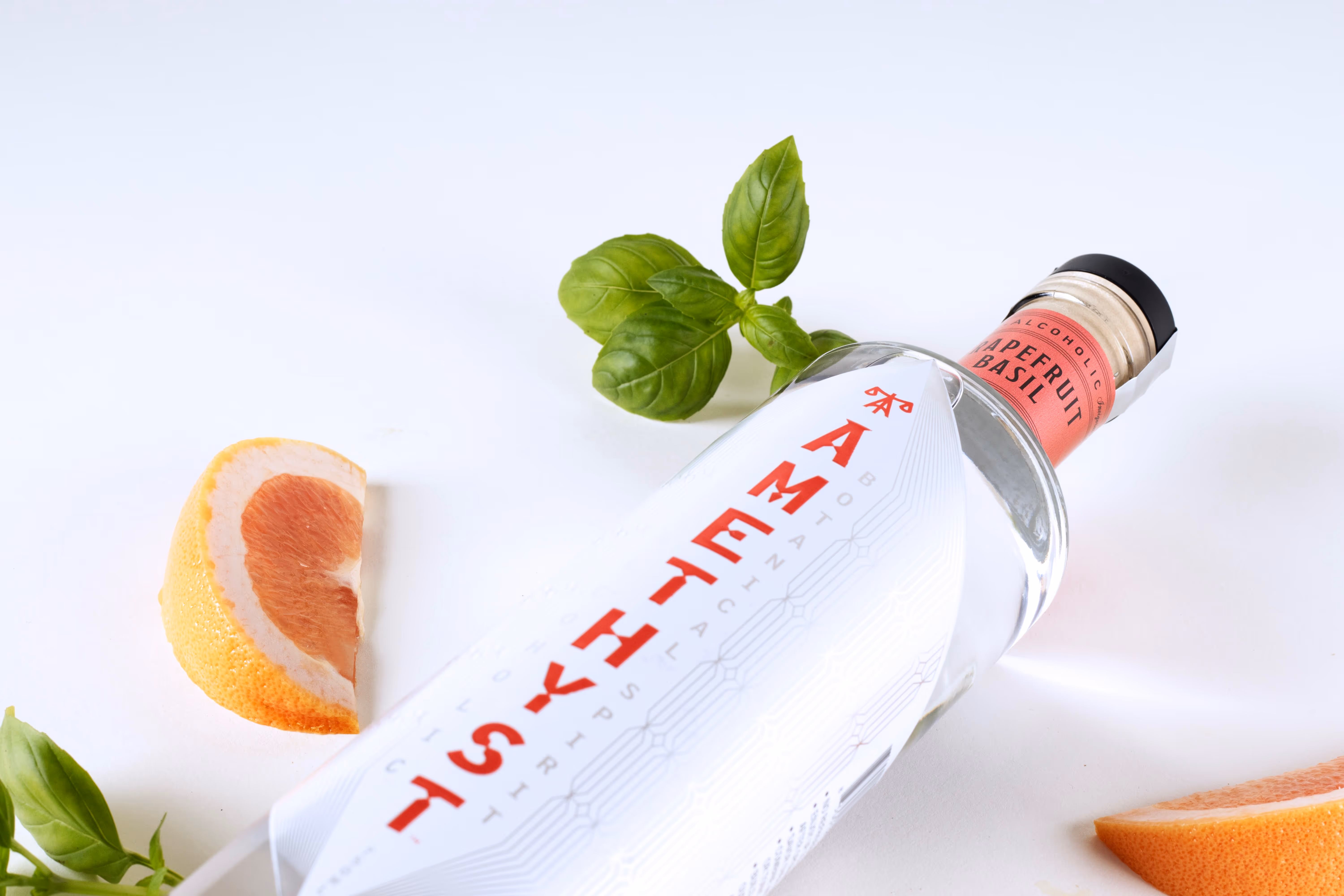 Bottle of Amethyst Grapefruit Basil resting on its back.