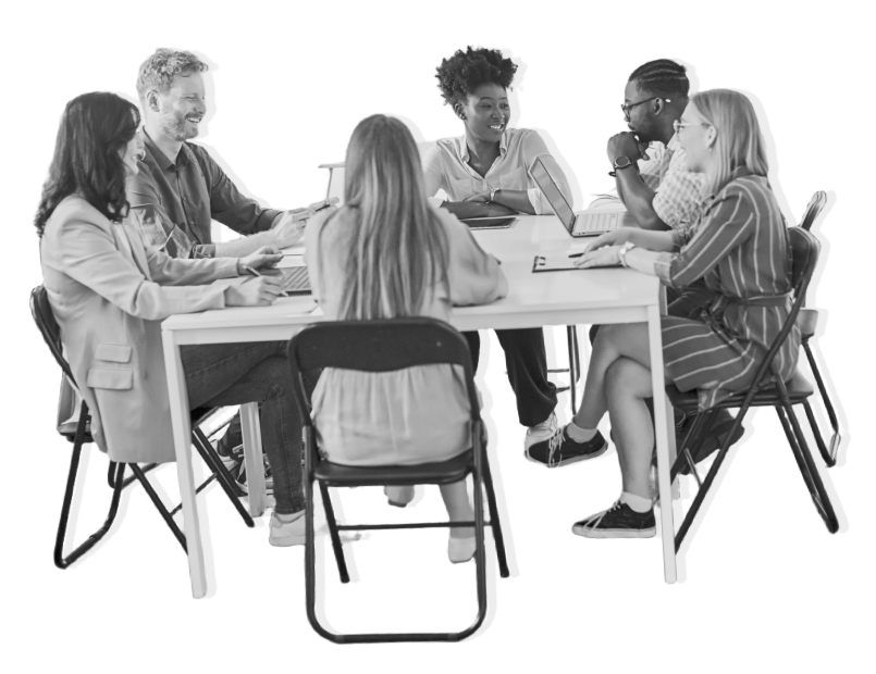 A diverse, multi-gender and multi-racial business team seated around a white table, engaged in an intense discussion. The image is in greyscale, set against a bright white background.