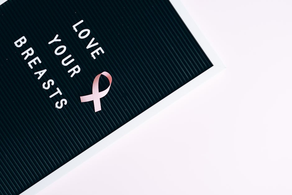 Inspirational letter board with pink ribbon promoting breast cancer awareness and self-love.