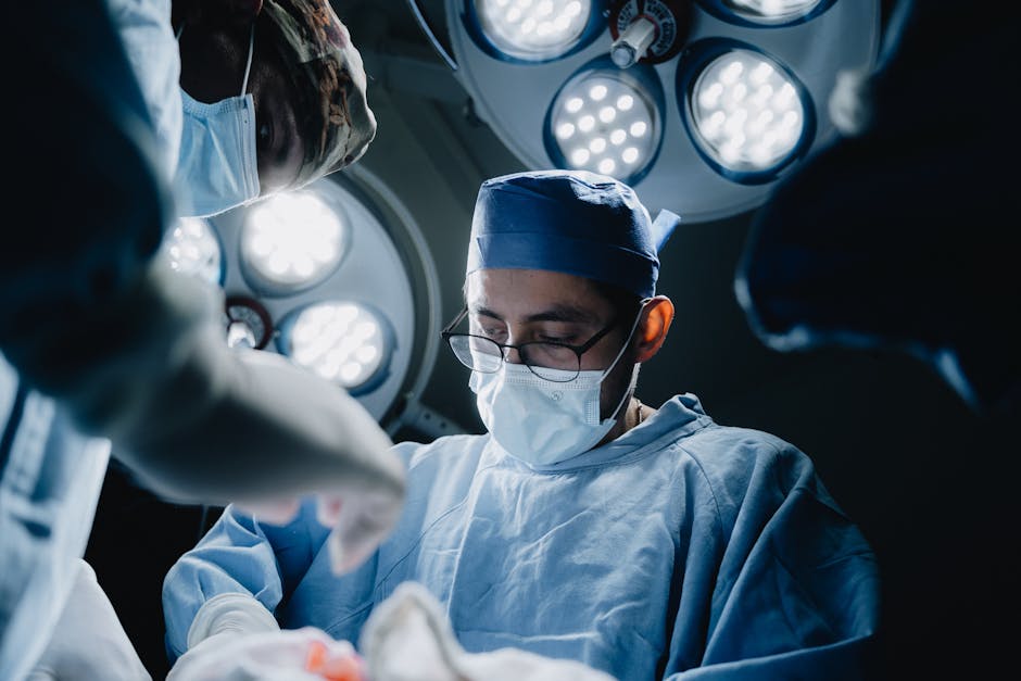 Surgeons performing a medical procedure in a well-lit, modern operating room in Mexico.