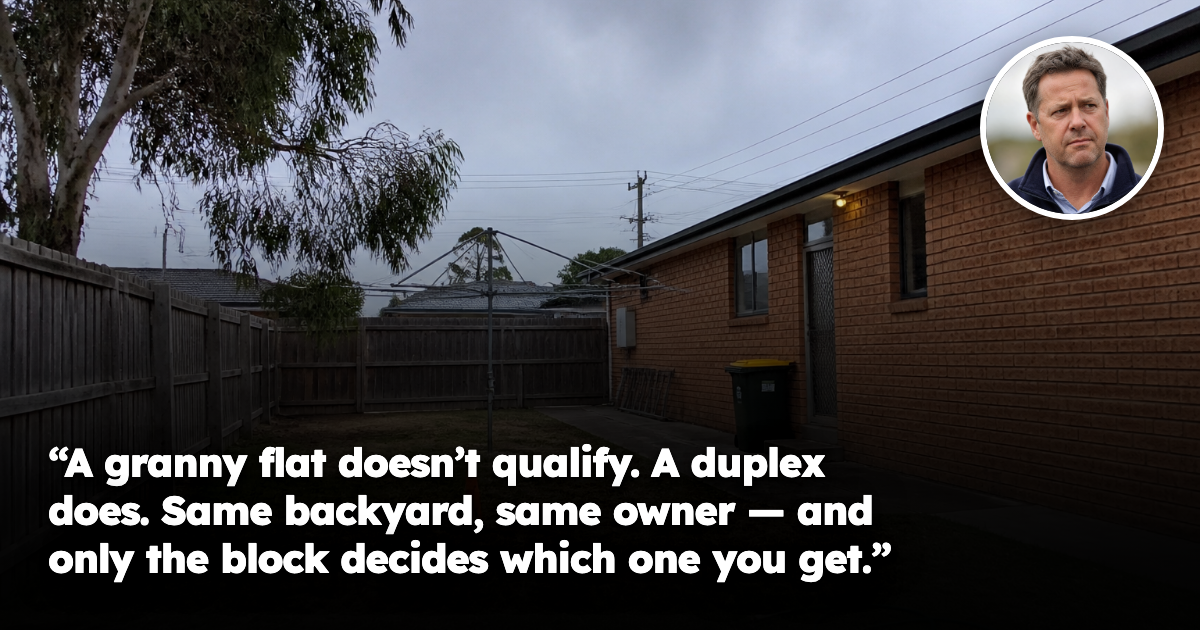 An ordinary Australian suburban backyard on an overcast day, with a patchy dry lawn, timber paling fence, rotary clothesline and a wooden surveyor peg with orange tape in the grass behind a plain brick veneer house. No people present.