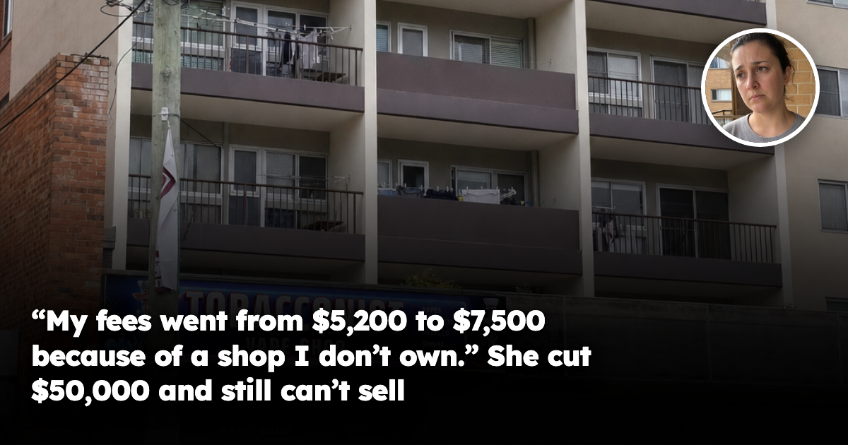 A mid-rise residential apartment building above ground-floor retail on an Australian street, with stacked balconies, air-conditioning units and a power pole in front of the shopfronts below.
