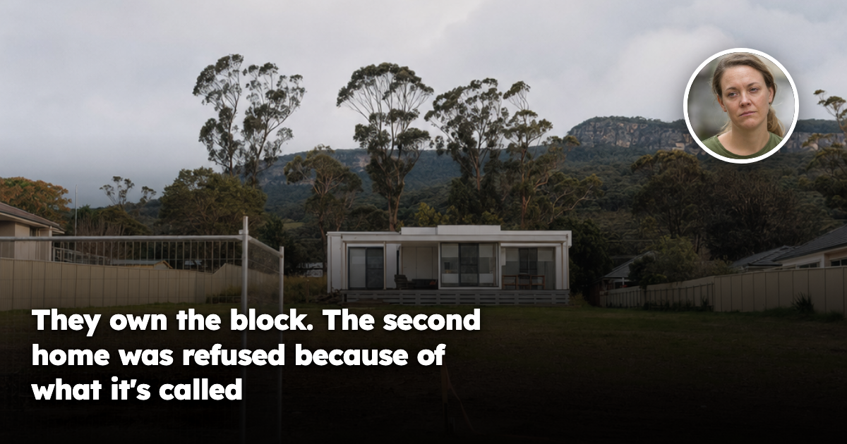 A large Australian suburban block with a modern modular home positioned at the rear and the front half of the land left empty, marked only by a surveyor's peg and a temporary construction fence.