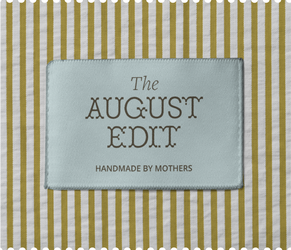 Clothing label on striped fabric reading 'The August Edit Handmade by Mothers'.
