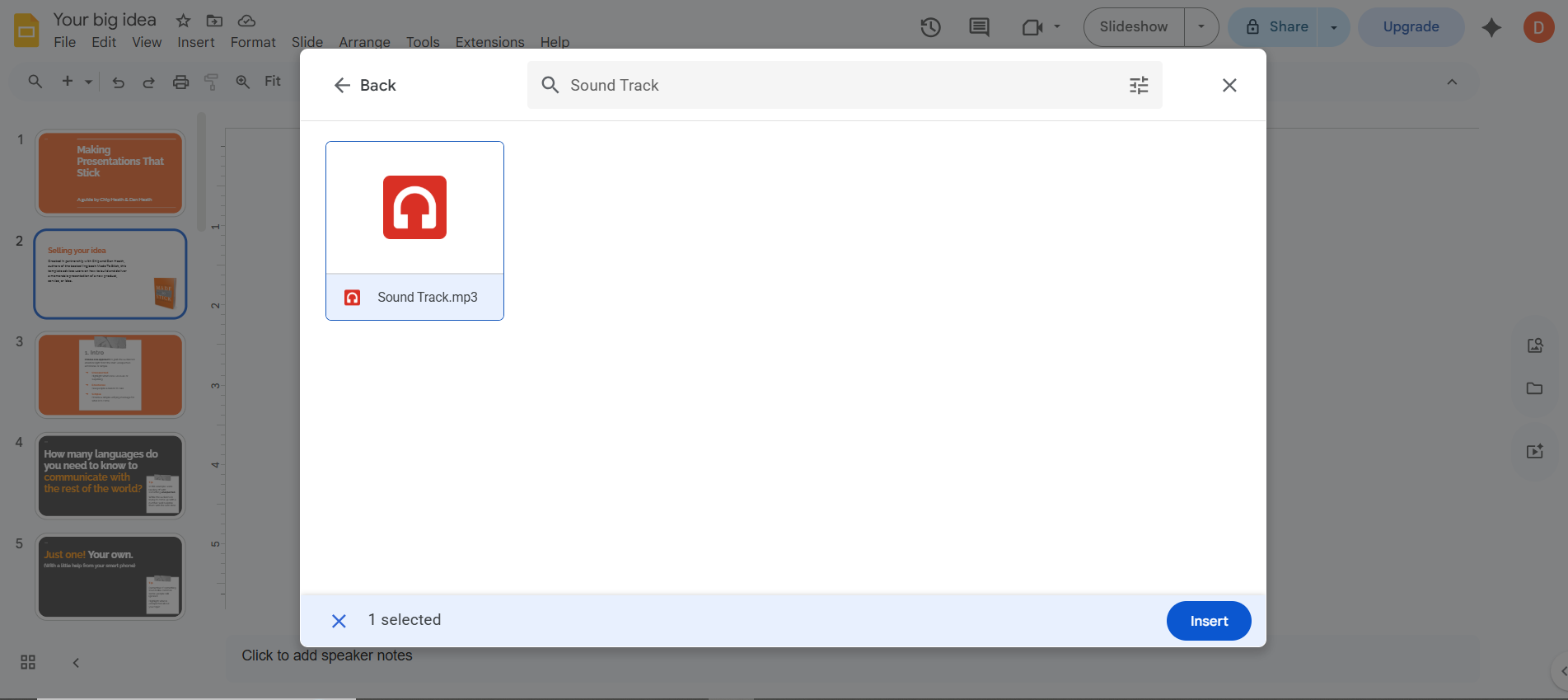 How to add audio to Google Slides — audio file highlighted in blue inside the Insert Audio popup with the blue Select button visible