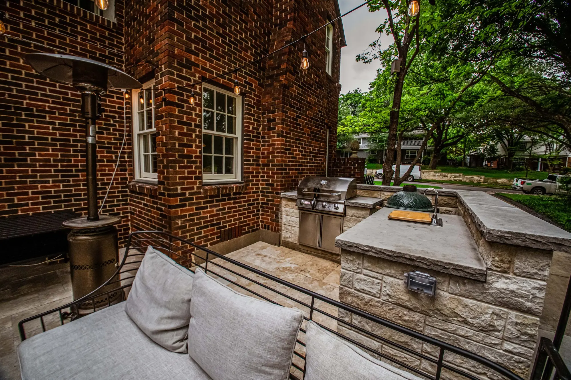 A cozy patio featuring a grill and a comfortable couch, perfect for outdoor gatherings and relaxation.