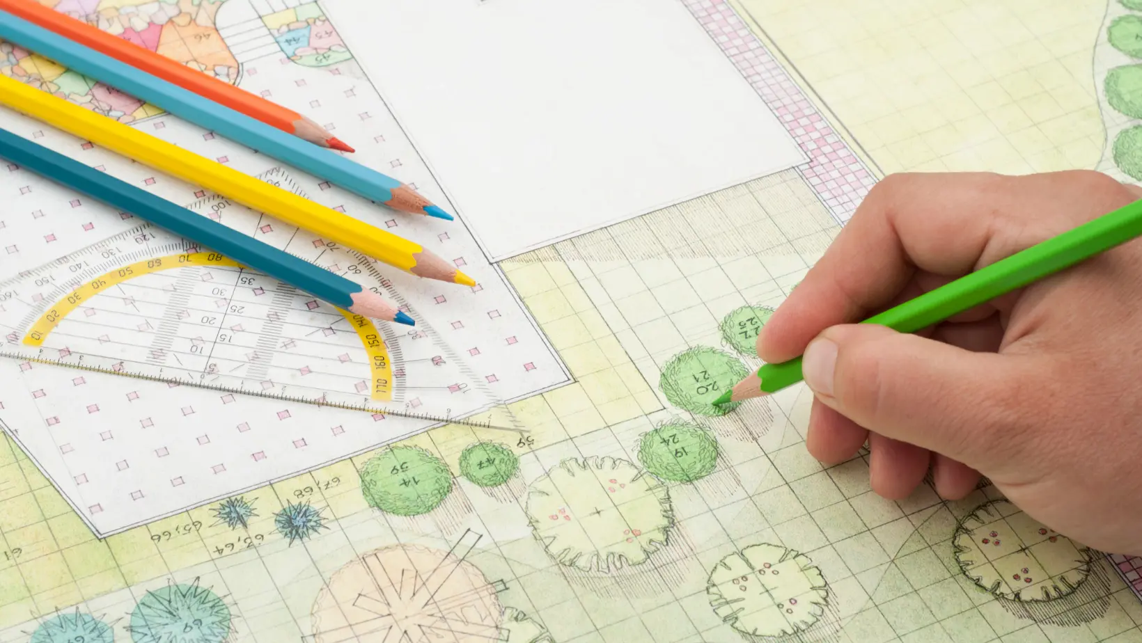 A person skillfully draws on paper using a variety of colored pencils, showcasing their artistic talent and creativity