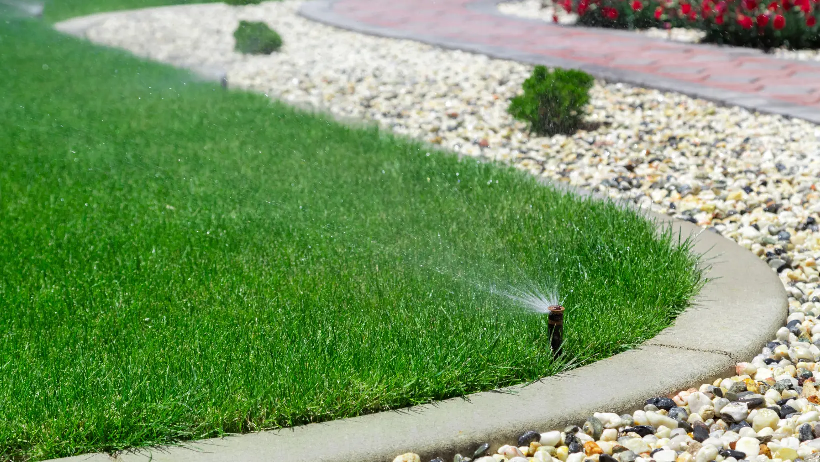 A garden sprinkler efficiently waters a lush green lawn, enhancing the beauty of the outdoor space