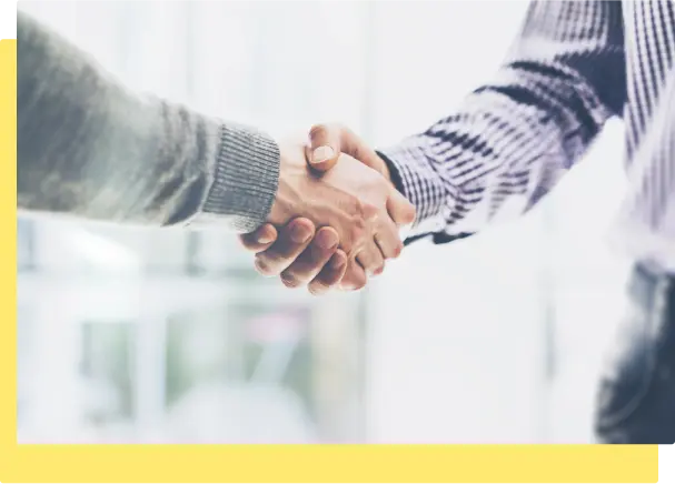 A business meeting scene featuring two individuals shaking hands, representing partnership and mutual understanding