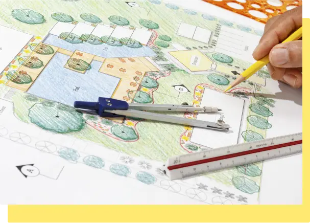 A person sketches a detailed landscape design on paper, showcasing creativity and planning in outdoor space design
