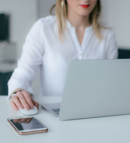 Frau sitzt an ihrem Laptop
