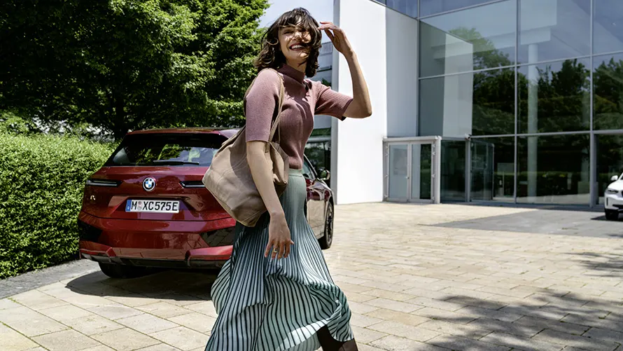Frau vor einem roten BMW – Stil und Alltagstauglichkeit im Autohaus BMW Köhler in Karlstadt