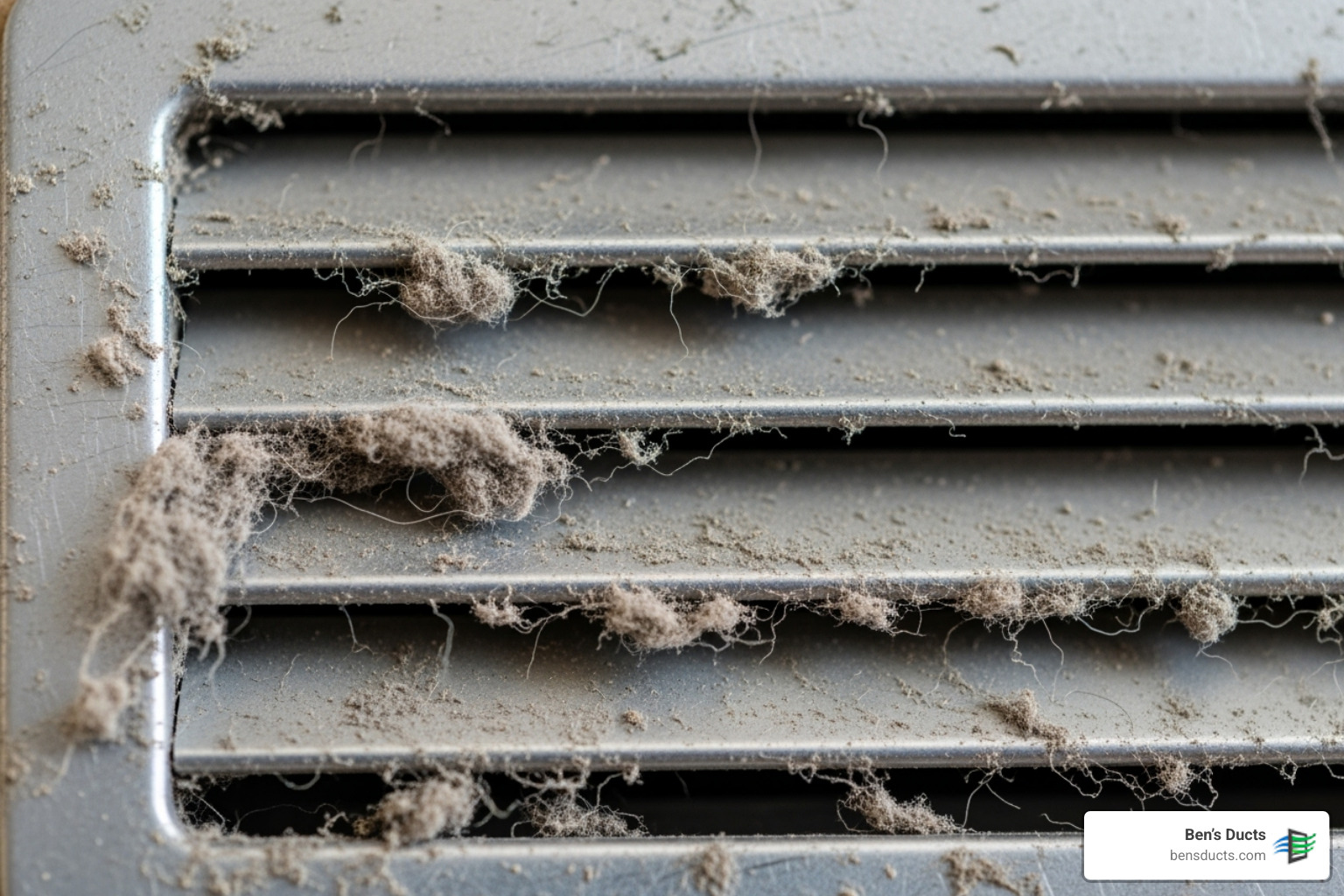 A close-up image of a dusty air vent cover with visible lint and debris accumulation, indicating a need for cleaning. - cleveland air duct cleaning