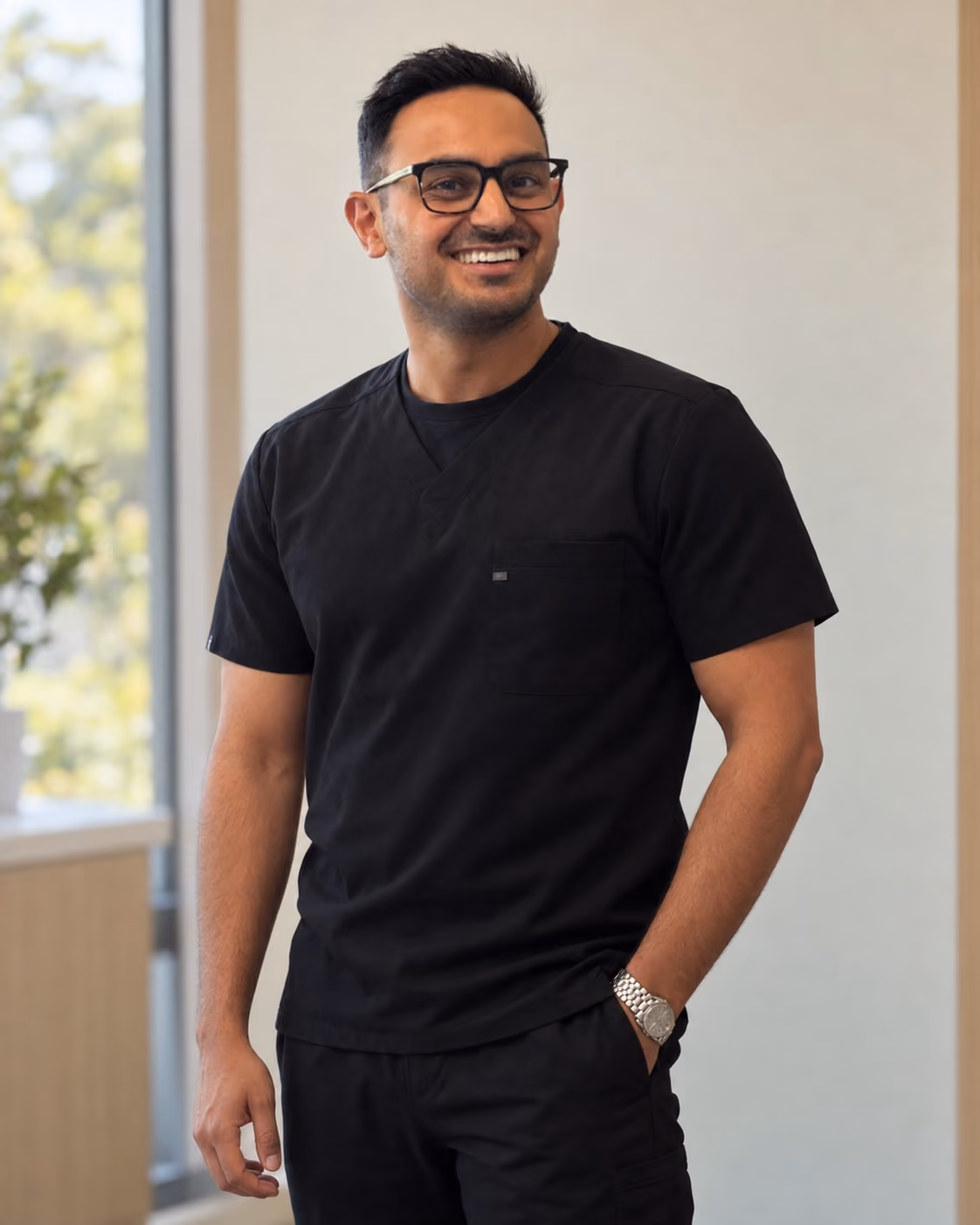 Dr. Shawn Sharma standing in black scrubs at Palo Alto Oral Health