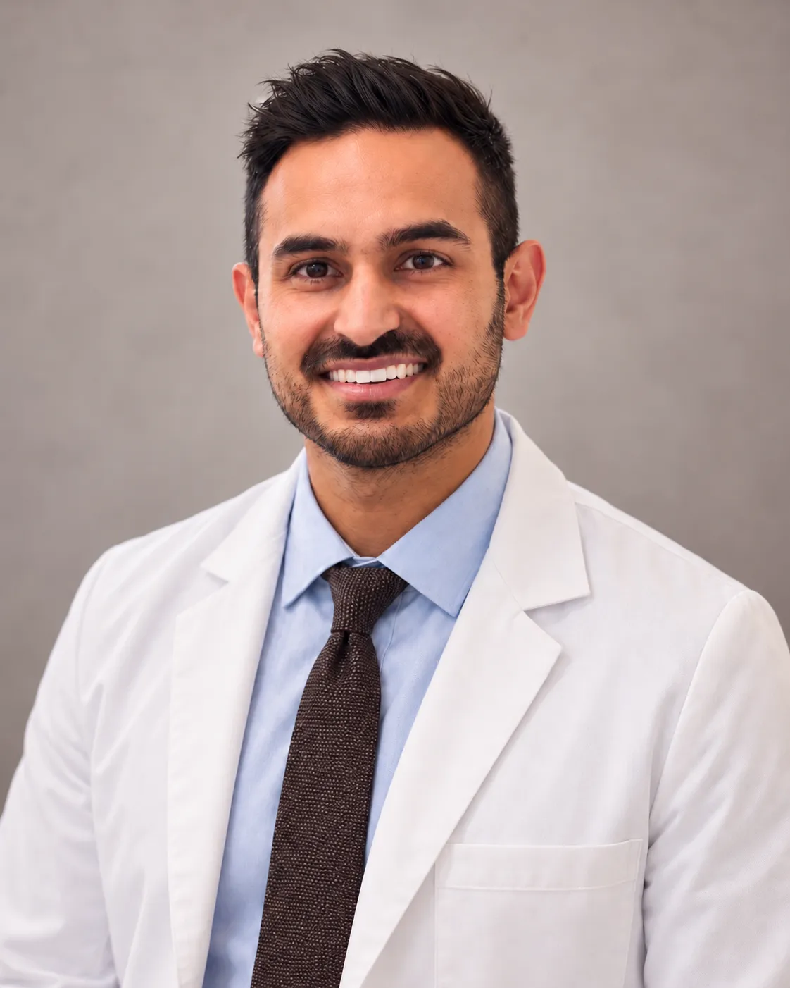 Dr. Shawn Sharma in a white coat and tie