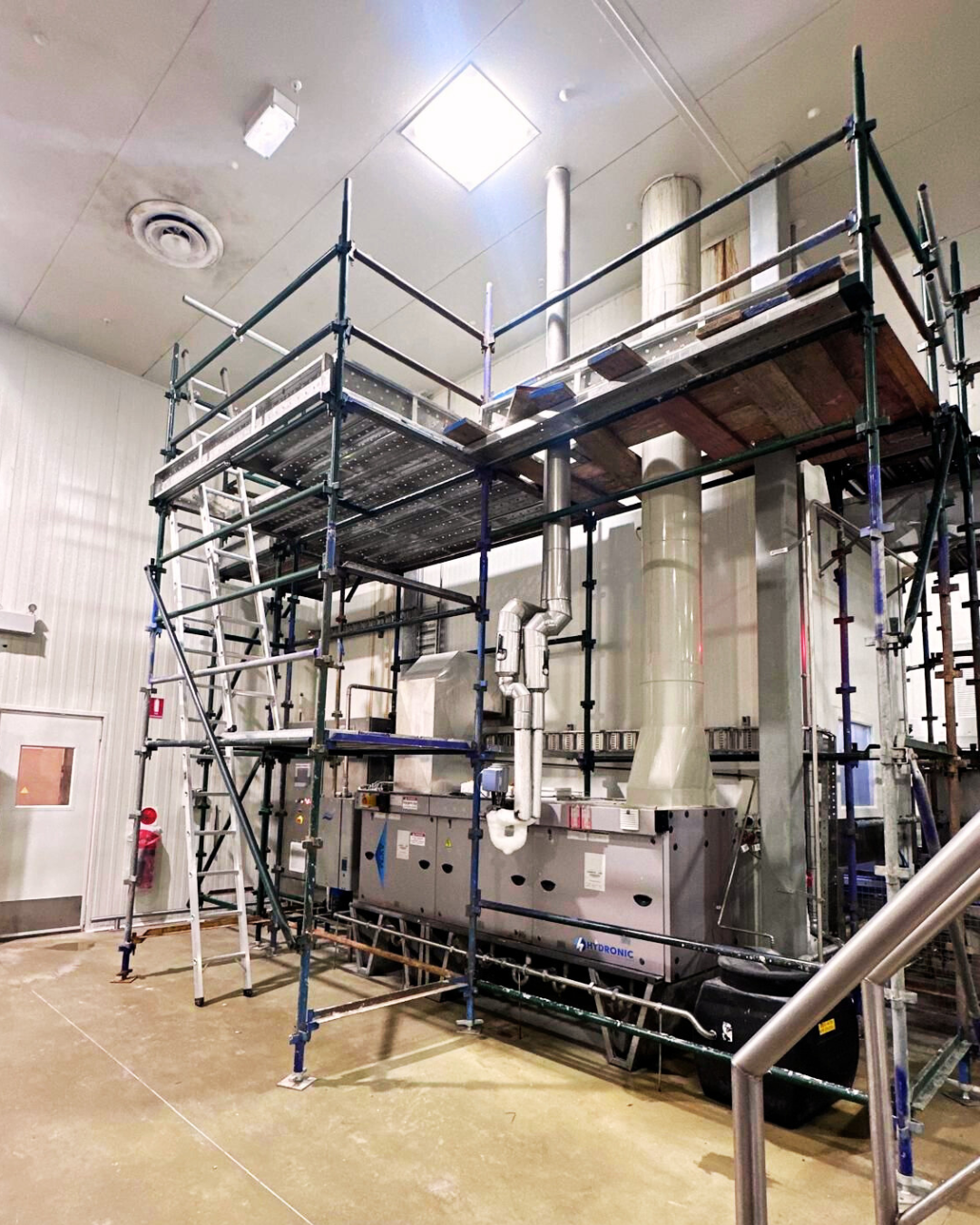 Interior view of a construction building showcasing scaffolding and work in progress